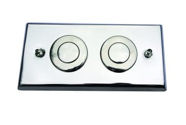 2 way switch Rectangular chrome dual-flush toilet plate features two circular push buttons and two screw heads, reflects light and sits mounted against a plain white background.