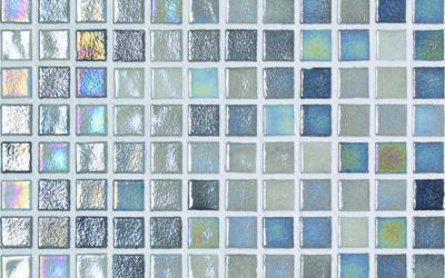 A grid of small glossy square mosaic tiles reflecting iridescent blue and silver hues, each separated by thin white grout, forming a uniform decorative tiled panel.